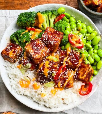 sticky gochujang tofu bowl with edamame, broccoli, and kimchi