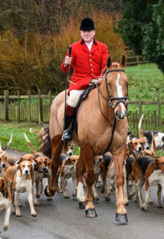 Photo shows huntsman John Holliday and whippers-in Sam and Poppy with the Duke of Rutland's hounds for The Belvoir Hunt's Boxing Day meet in December 2021