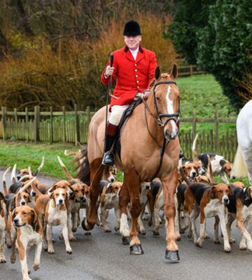 Photo shows huntsman John Holliday and whippers-in Sam and Poppy with the Duke of Rutland's hounds for The Belvoir Hunt's Boxing Day meet in December 2021