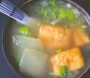 winter melon soup with tofu puffs with spring onion and a simple broth