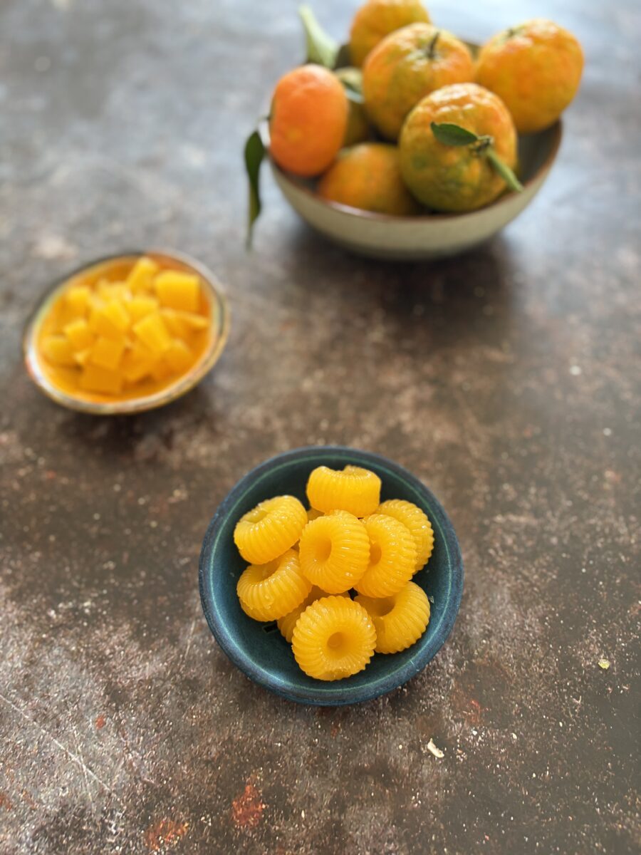 two-ingredient vegan mandarin gummies made with juice and agar agar in a cute circular mold