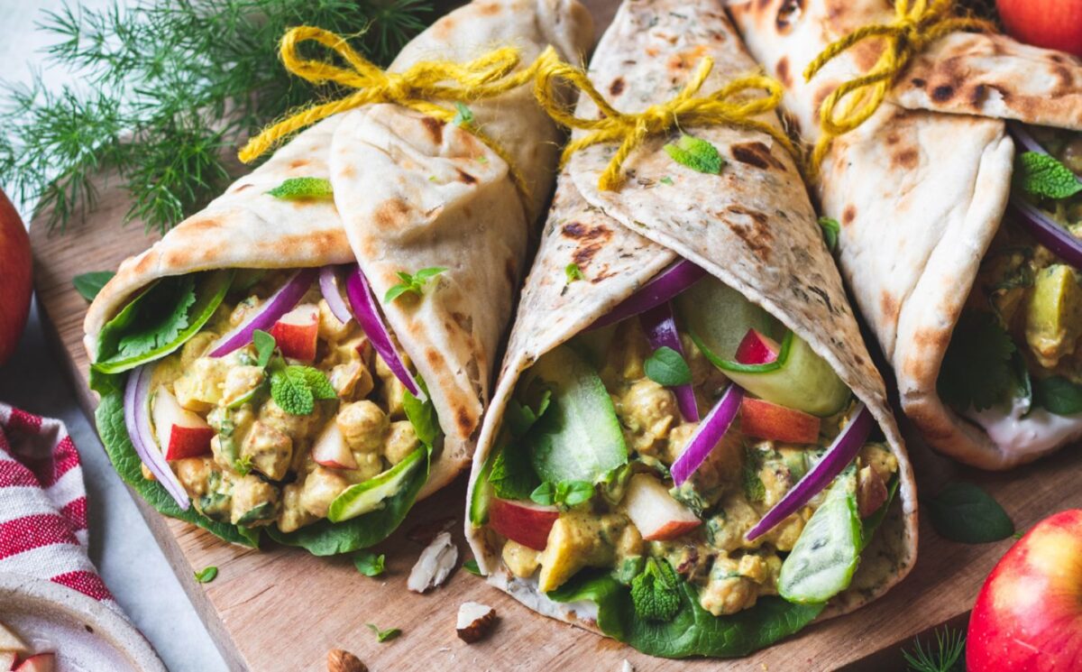 Christmas coronation chickpea naan wraps with vegan yogurt, chickpeas, dried cranberries, apple, and more