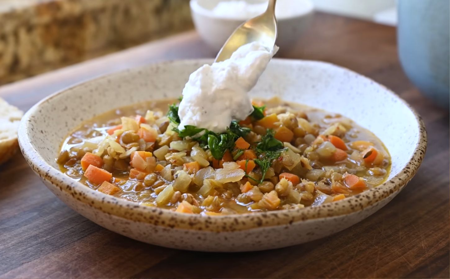 Mediterranean lentil soup finished with a spoonful of plant-based yogurt topping