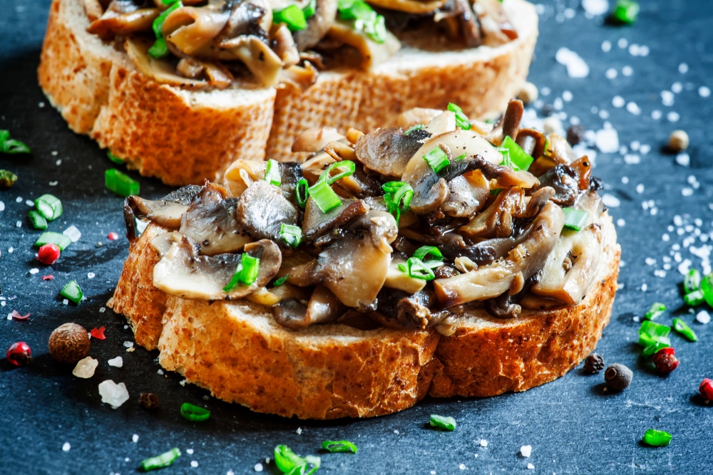 Mushrooms and green onions on bread to illustrate the health benefits of mushrooms