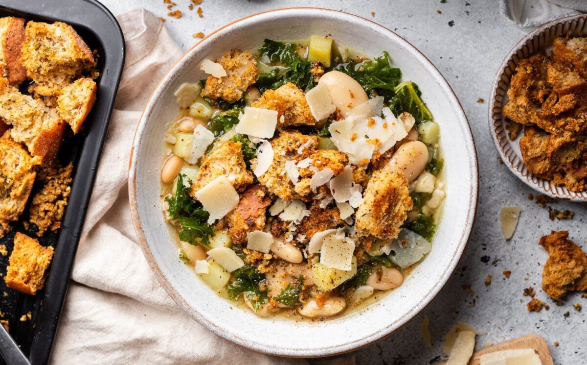 a bowl of rustic white bean and kale soup with homemade croutons for quick cold weather meals