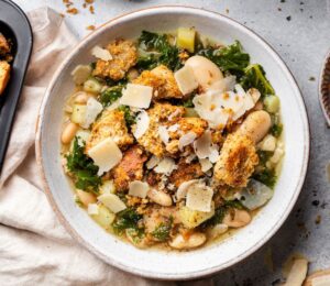 a bowl of rustic white bean and kale soup with homemade croutons for quick cold weather meals