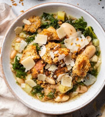 a bowl of rustic white bean and kale soup with homemade croutons for quick cold weather meals