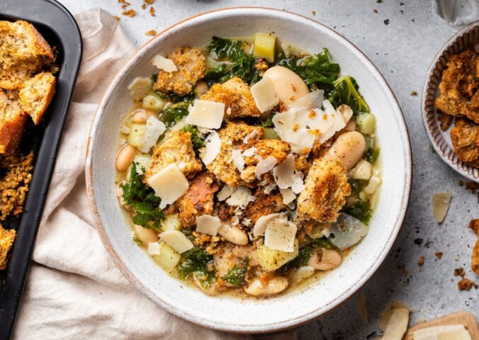 a bowl of rustic white bean and kale soup with homemade croutons for quick cold weather meals
