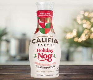 Photo shows the Califia Farms "Holiday Nog," a vegan take on eggnog without animal ingredients or alcohol, against a festive, Christmas backgroun