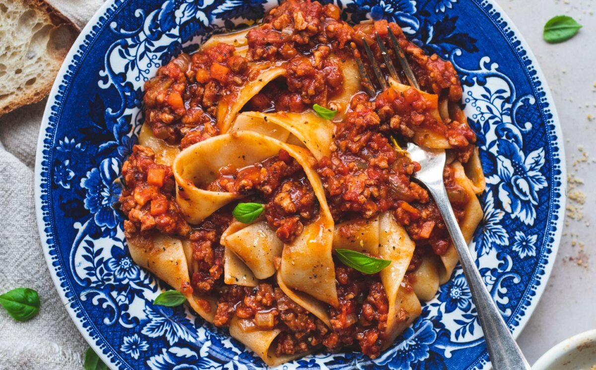 vegan classic Bolognese made with ragu-style tomato sauce and topped over pappardelle pasta for high-protein pasta dishes