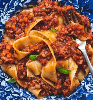 vegan classic Bolognese made with ragu-style tomato sauce and topped over pappardelle pasta for high-protein pasta dishes