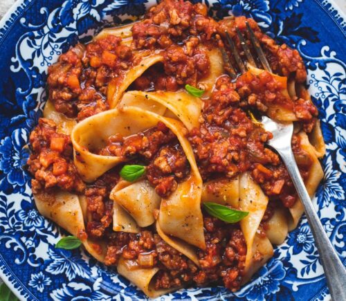 vegan classic Bolognese made with ragu-style tomato sauce and topped over pappardelle pasta for high-protein pasta dishes
