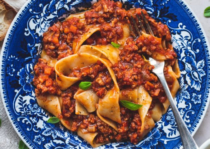 vegan classic Bolognese made with ragu-style tomato sauce and topped over pappardelle pasta for high-protein pasta dishes