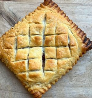 copycat Greggs vegan lattice pastry festive edition with vegan chicken, bacon, stuffing, and cranberry sauce wrapped in vegan puff pastry