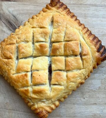copycat Greggs vegan lattice pastry festive edition with vegan chicken, bacon, stuffing, and cranberry sauce wrapped in vegan puff pastry