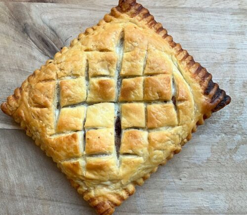 copycat Greggs vegan lattice pastry festive edition with vegan chicken, bacon, stuffing, and cranberry sauce wrapped in vegan puff pastry