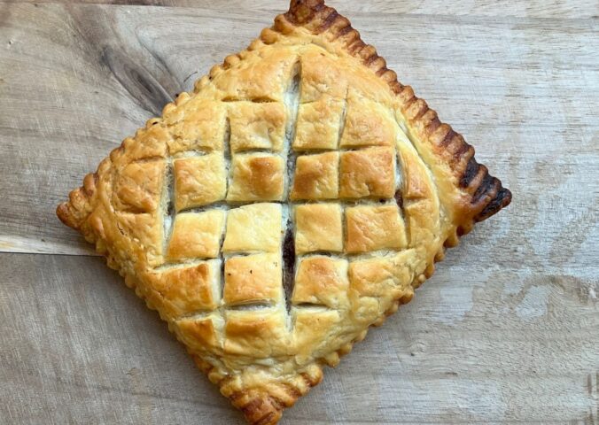 copycat Greggs vegan lattice pastry festive edition with vegan chicken, bacon, stuffing, and cranberry sauce wrapped in vegan puff pastry
