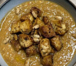 pumpkin and green lentil soup with pumpkin seeds and toasted bread