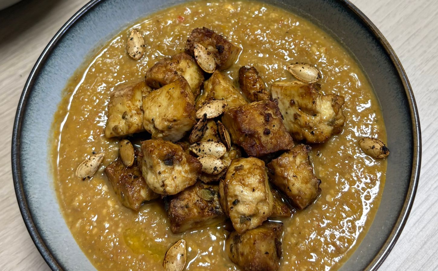 pumpkin and green lentil soup with pumpkin seeds and toasted bread