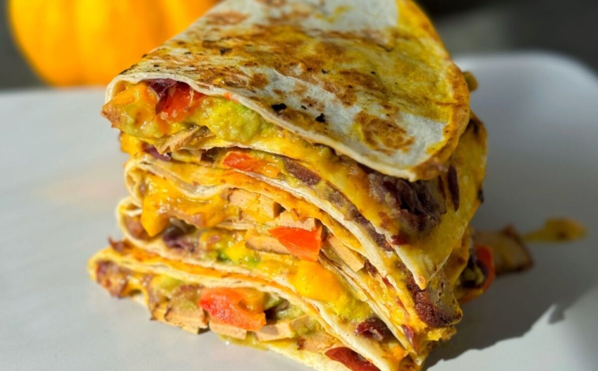 a stack of 15-minute quesadillas with pumpkin cheese, refried beans, and tofu for quick cold weather meals