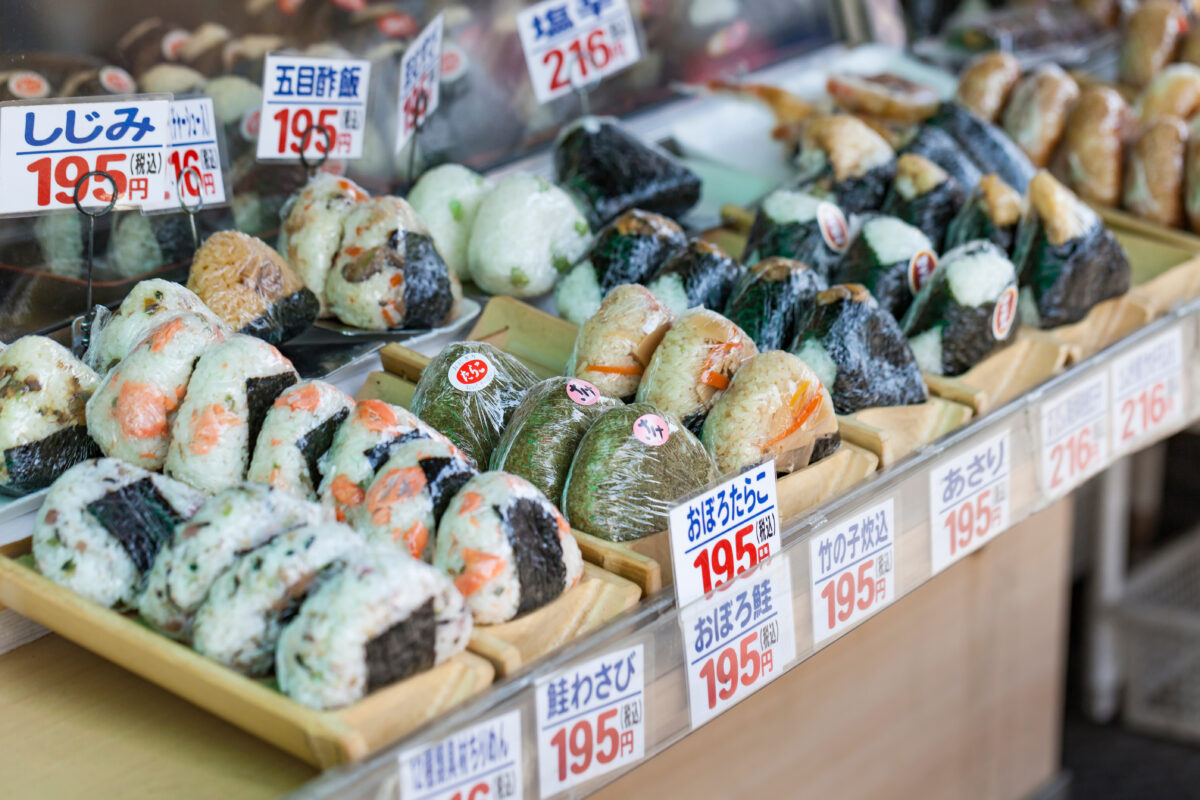 Photo shows a selection of pre-wrapped sushi products - a popular convenience food in Japan - displayed by a vendor