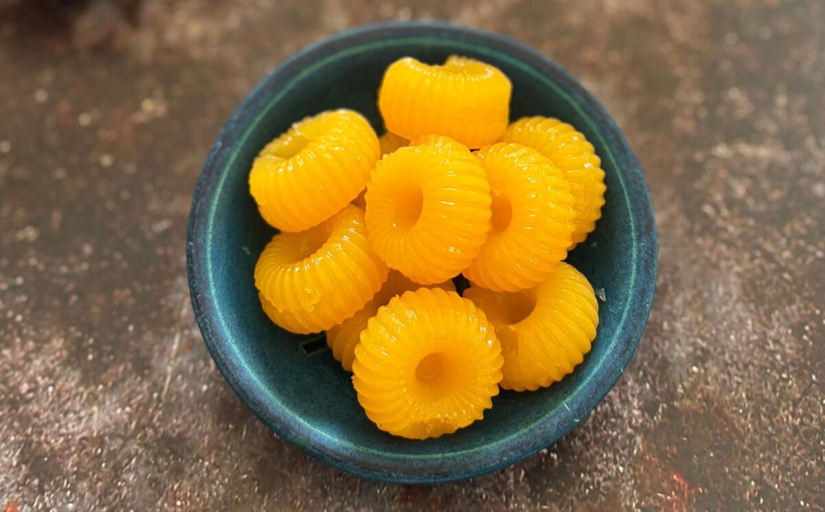 two-ingredient vegan mandarin gummies made with juice and agar agar in a cute circular mold