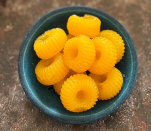 two-ingredient vegan mandarin gummies made with juice and agar agar in a cute circular mold