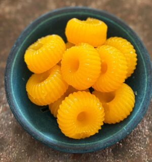 two-ingredient vegan mandarin gummies made with juice and agar agar in a cute circular mold