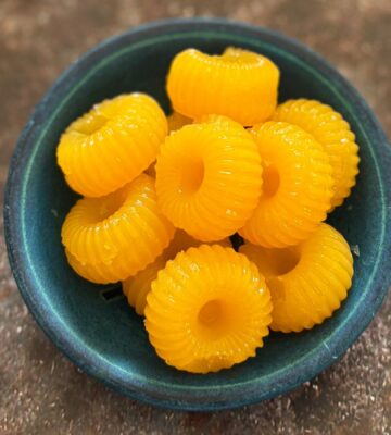 two-ingredient vegan mandarin gummies made with juice and agar agar in a cute circular mold