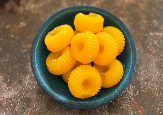 two-ingredient vegan mandarin gummies made with juice and agar agar in a cute circular mold