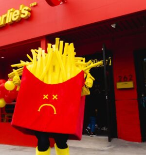 Photo shows a Mr Charlie's French fries mascot posing outside a recently opened branch of the "vegan McDonald's" in Los Angeles, California