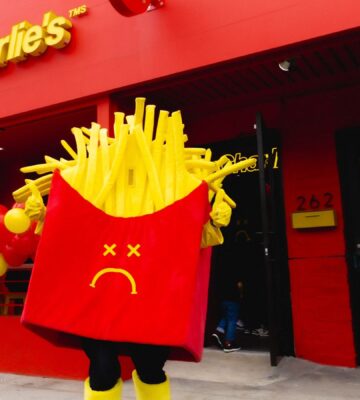 Photo shows a Mr Charlie's French fries mascot posing outside a recently opened branch of the "vegan McDonald's" in Los Angeles, California