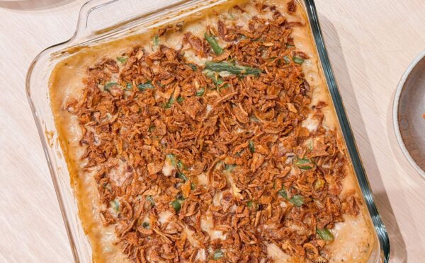 a dish of vegan parmesan bacon green bean casserole with mushroom soup and French-fried onions