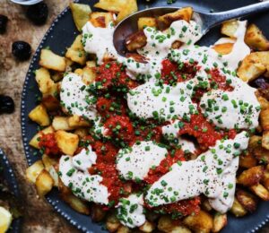 patatas bravas with vegan mayo, chili, tomato, and garlic for after NYE