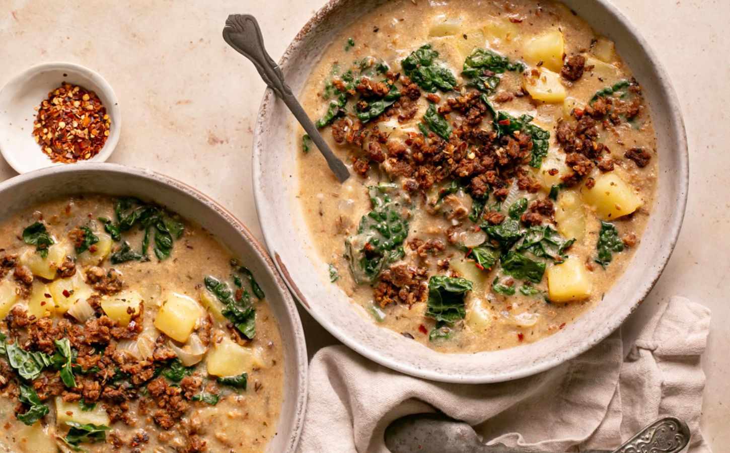 vegan zuppa Toscana soup with potatoes, kale, nutritional yeast, and vegan beef