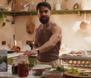 Former chef Gaz Oakley stands behind the kitchen counter of his off-grid home in rural Wales