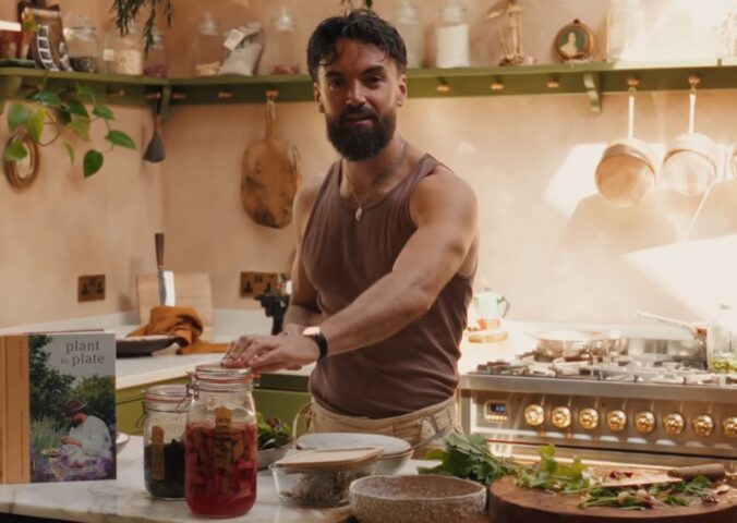 Former chef Gaz Oakley stands behind the kitchen counter of his off-grid home in rural Wales