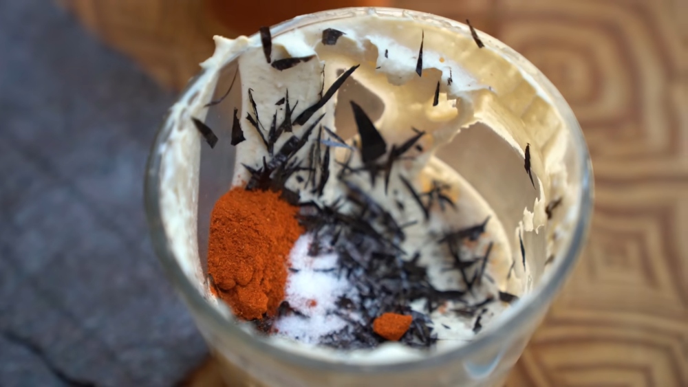 Cashew cream cheese base with smoked paprika and seasoning before mixing into lox-flavored spread