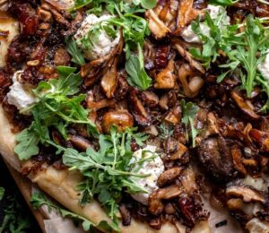 a caramelized shallot and wild mushroom pizza with dates and arugula for weeknight vegan dinners