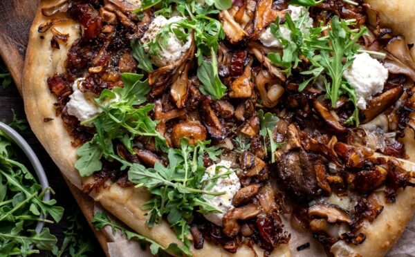 a caramelized shallot and wild mushroom pizza with dates and arugula for weeknight vegan dinners