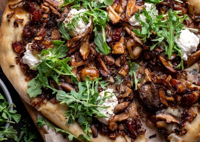 a caramelized shallot and wild mushroom pizza with dates and arugula for weeknight vegan dinners