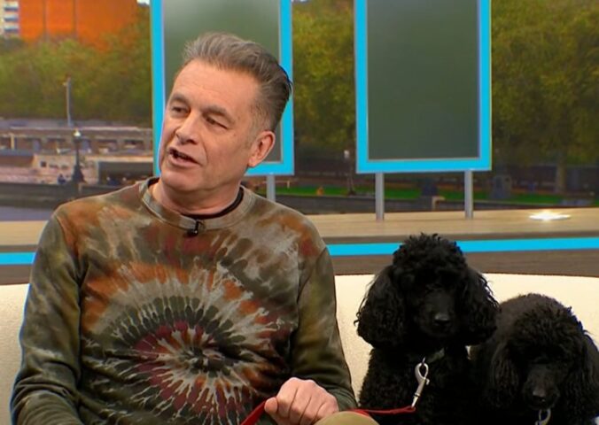 Photo shows Chris Packham, left, and his dogs Sid and Nancy, right, in a recent appearance on 'Good Morning Britain,' where Packham explained why his dogs were following a plant-based diet for Veganuary