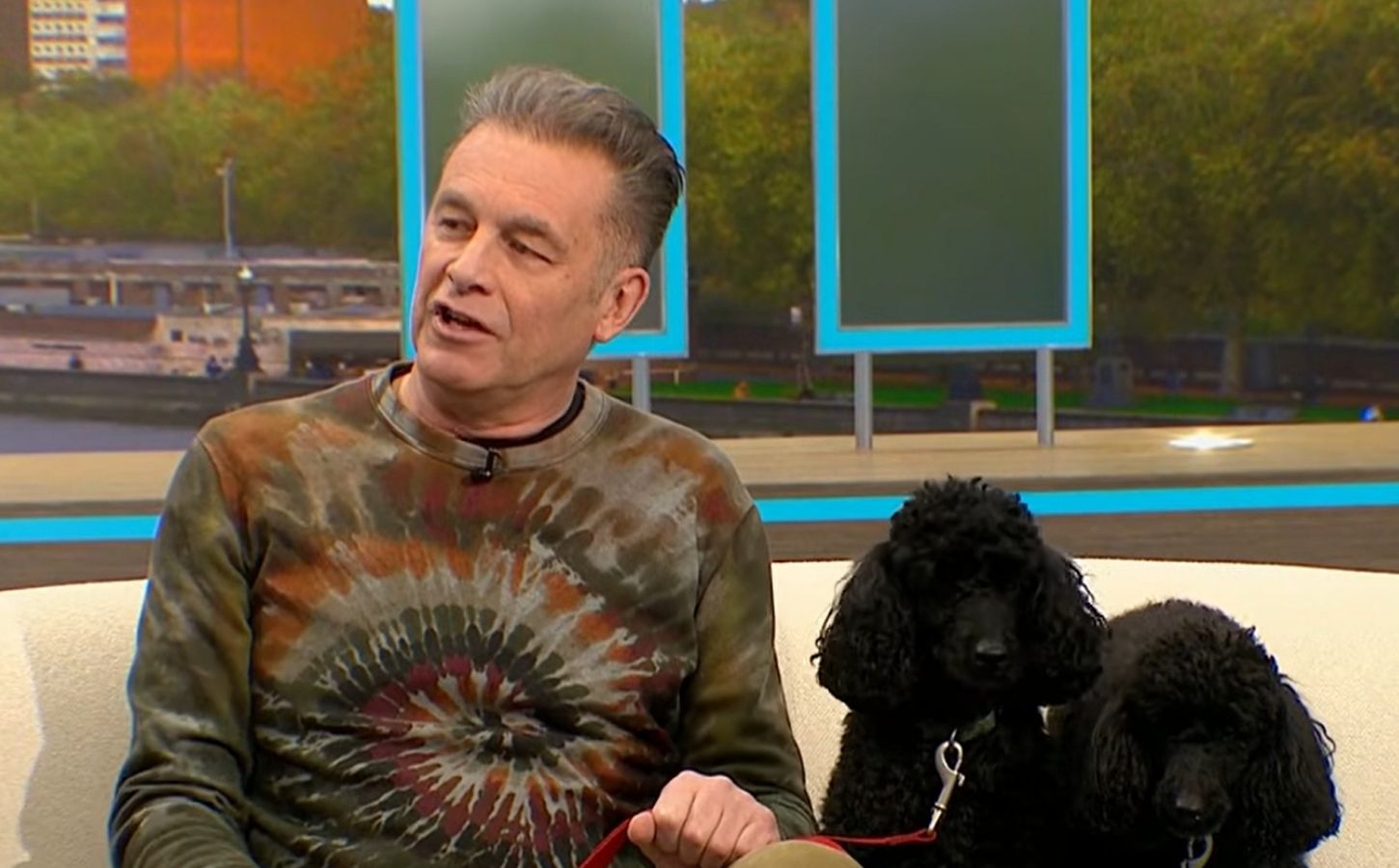 Photo shows Chris Packham, left, and his dogs Sid and Nancy, right, in a recent appearance on 'Good Morning Britain,' where Packham explained why his dogs were following a plant-based diet for Veganuary