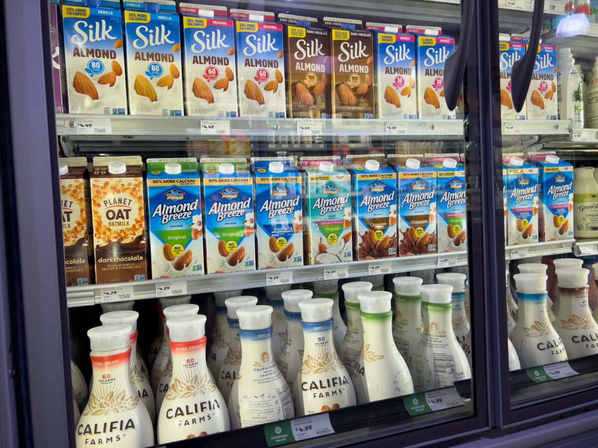 Photo shows a large supermarket refrigerator full of plant-based milk products