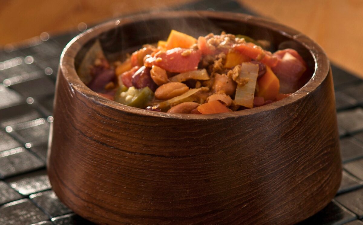 high-protein chili with tomato paste, refried beans, vegan ground beef, and garlic