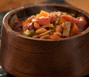 high-protein chili with tomato paste, refried beans, vegan ground beef, and garlic