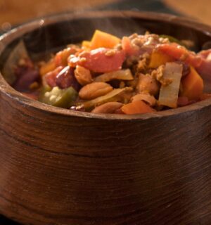 high-protein chili with tomato paste, refried beans, vegan ground beef, and garlic