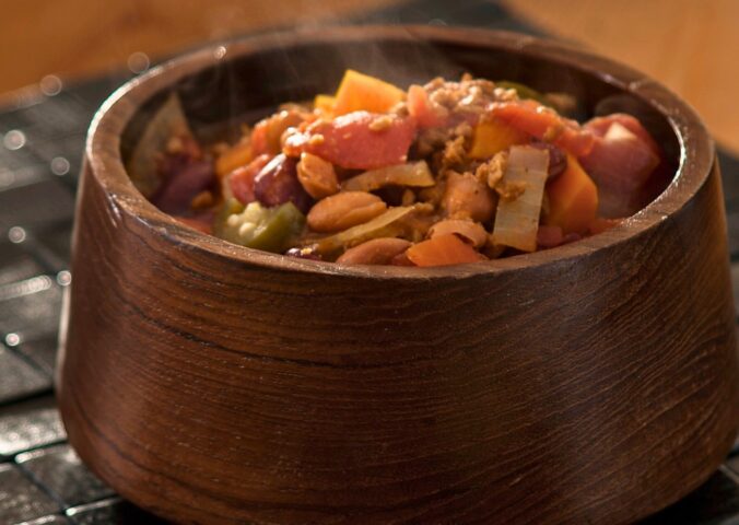 high-protein chili with tomato paste, refried beans, vegan ground beef, and garlic