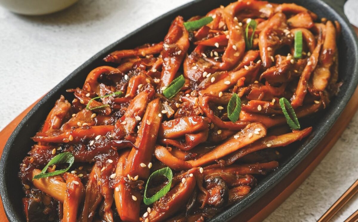 a picture of Korean bulgogi mushrooms made with king oyster mushrooms, and served with rice and vegan kimchi for weeknight vegan dinners