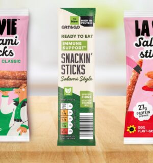 Photo shows the two new vegan Salami Stick products from La Vie, with Classic on the left and Spicy on the right, as well as a similar product from Aldi in the middle, the classic flavored "Snackin' Stick"